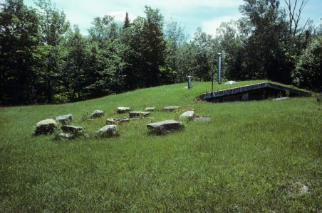 The north side of the house shows the full extent of the earth-sheltering. The east and west berms support the living roof.
